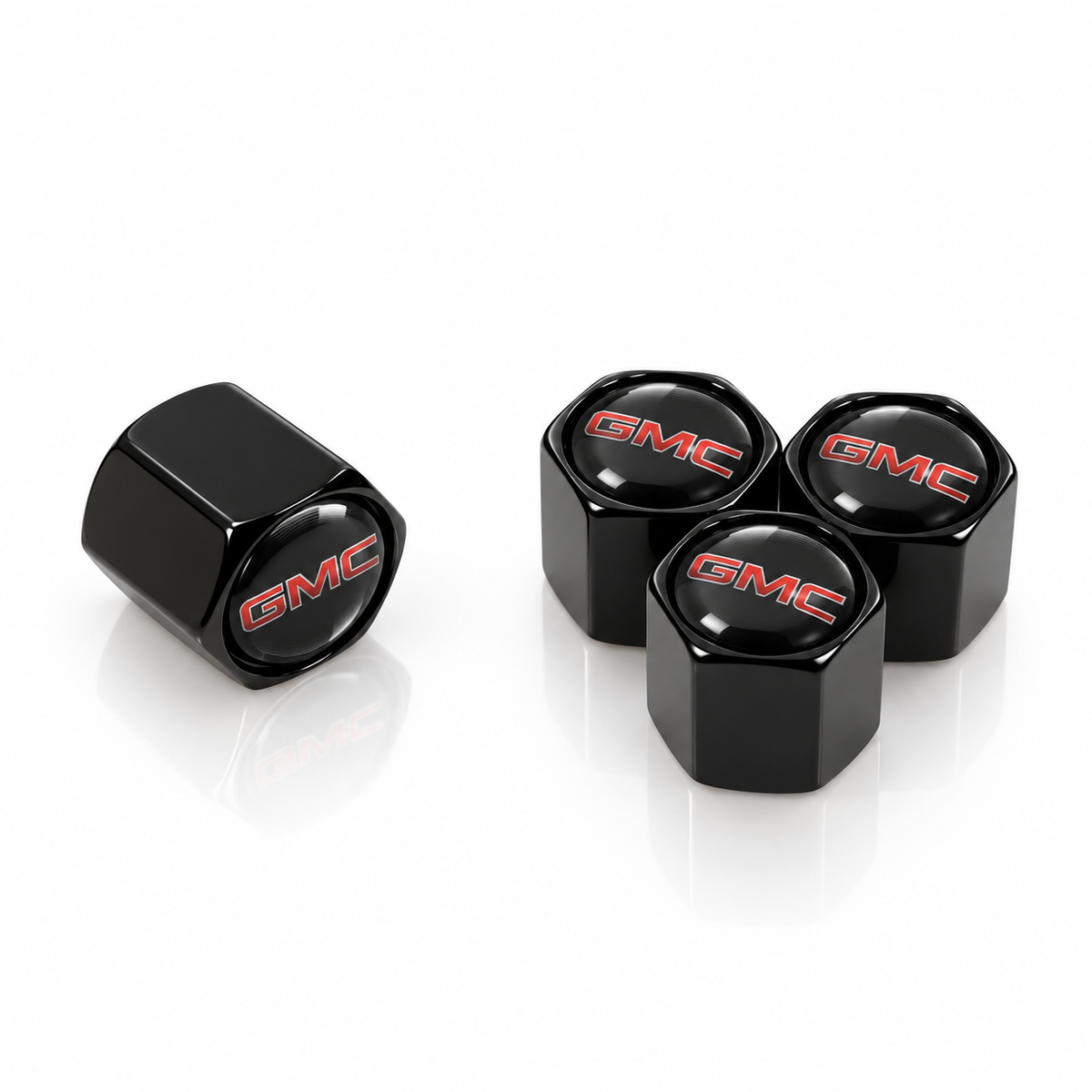 Set of four black hexagonal GMC valve caps with red GMC domed badges
